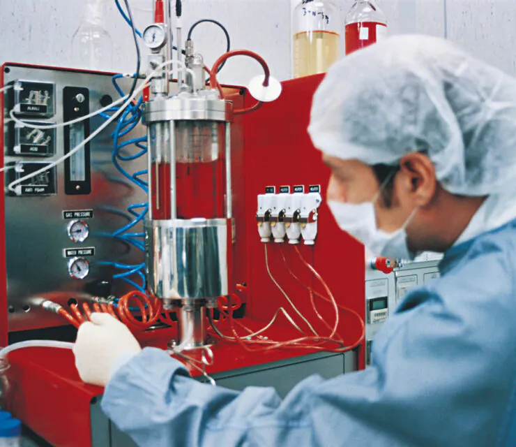 Scientist in a lab with red equipment