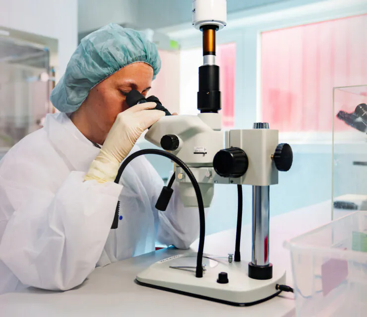 Woman looking through microscope